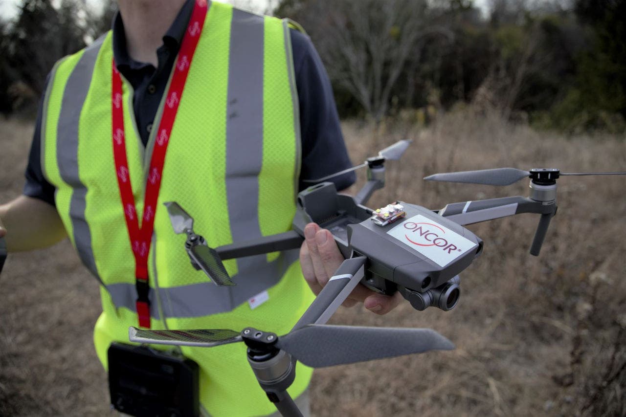 Oncor drone program Oncor employee holding drone