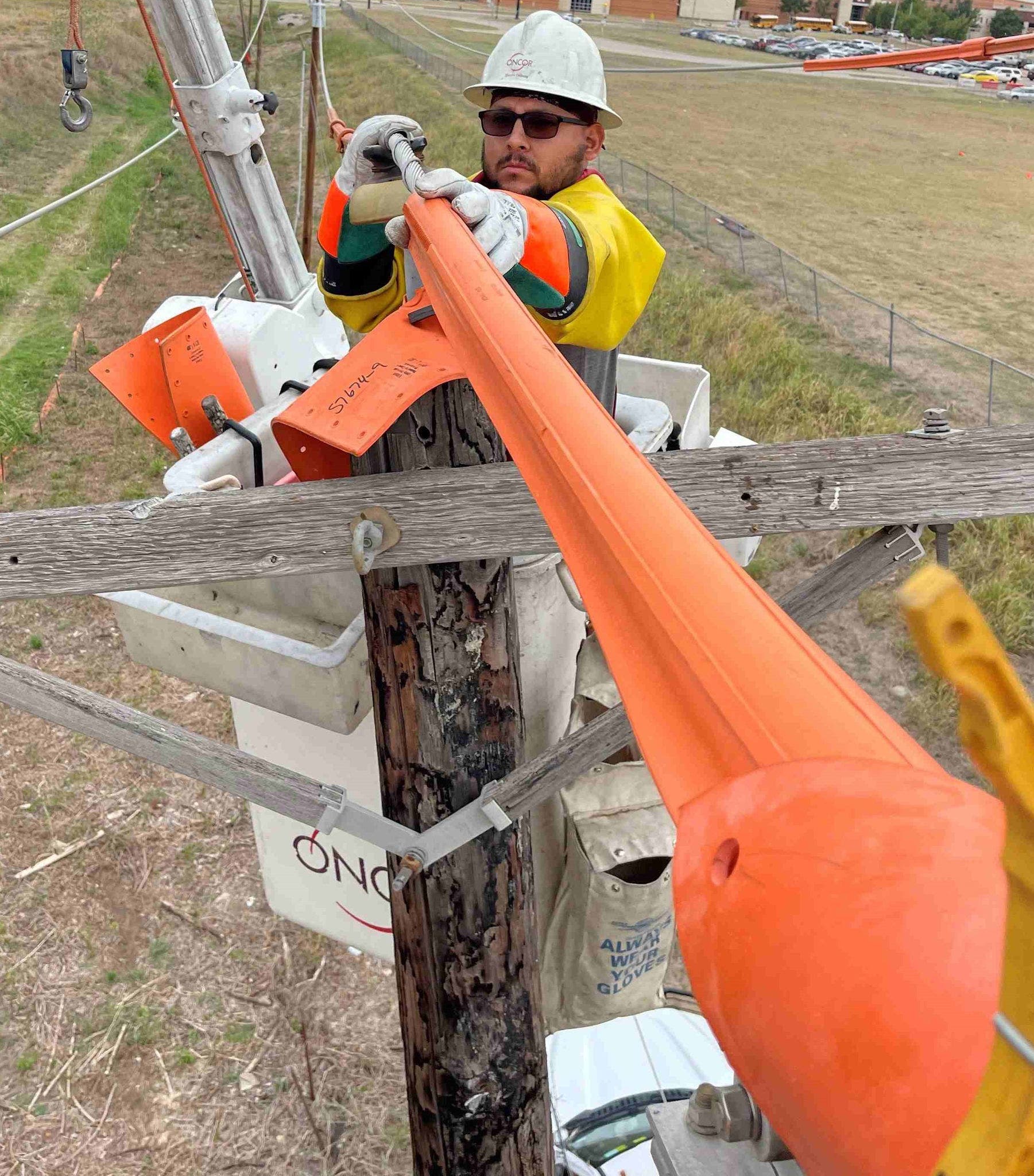 Cropped Daniel Ortiz Oncor lineman working on pole