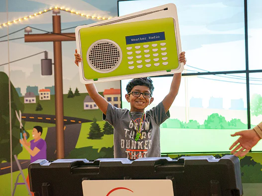 Student demonstrating items in storm safety kit